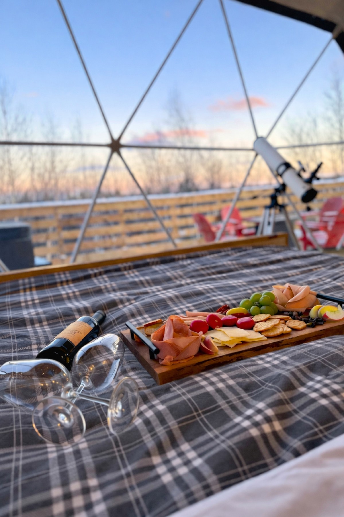 Charcuterie and wine board set out by the dome window