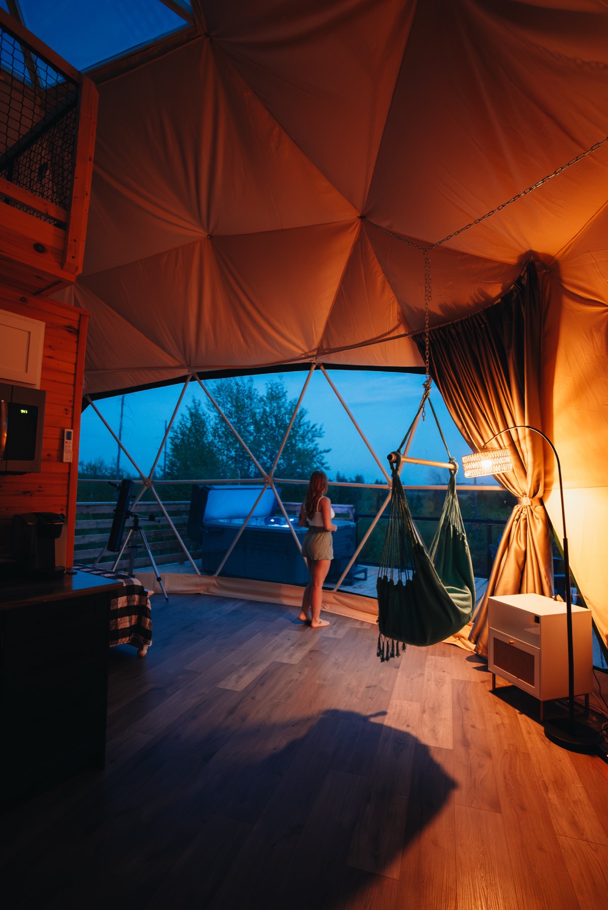 Guests relaxing in the private hot tub outside their dome