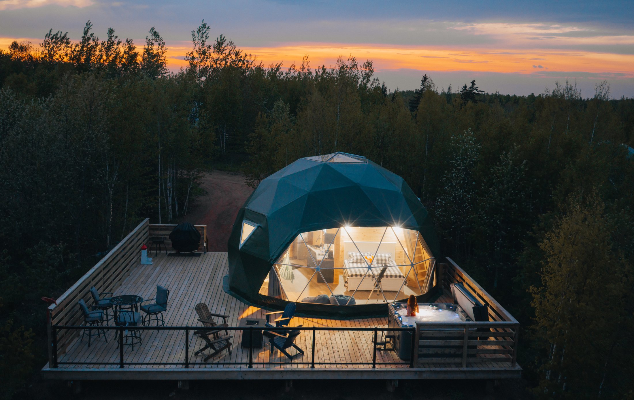 Aerial view of the glamping domes in the PEI forest at dusk